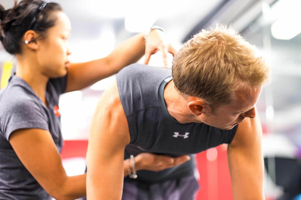 qualified pilates physiotherapist helping a patient